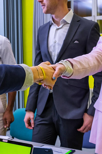 istock Business people shaking hands in modern office 2202163591