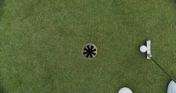 istock A man hits a ball with a golf club and it hits the target 2202166410