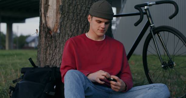 istock A young man inserts wireless headphones into his ears, starting to listen 2202166933