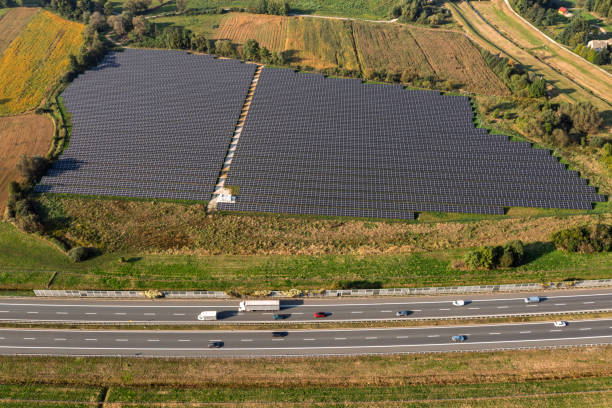 istock Solar power station and highway from above 2202167255