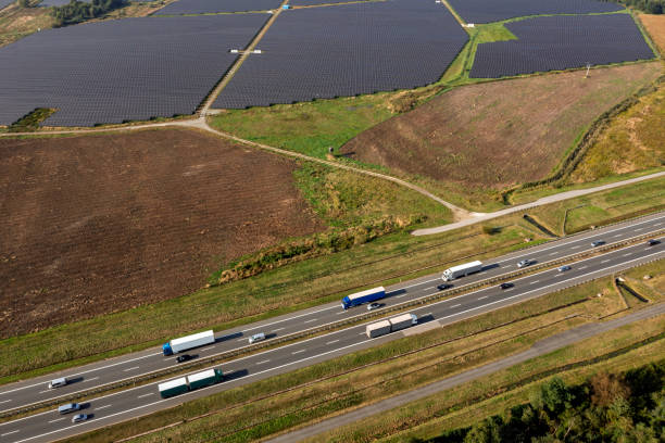 istock Solar power station and highway from above 2202167987