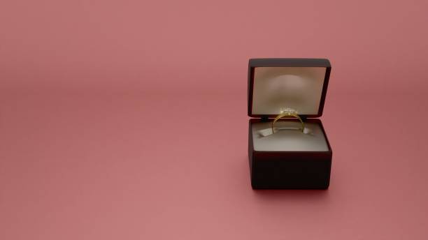 istock Elegant gold ring in black velvet box on champagne background 2202170452