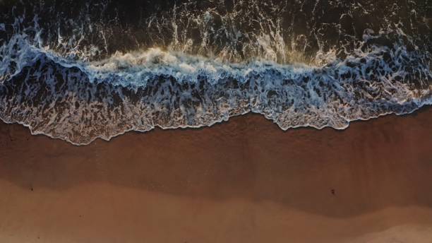 istock Top view from a drone of the coastline at high tide 2202171820