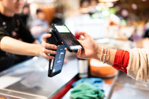 istock Customer paying with mobile phone at store checkout 2202171829