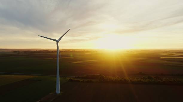 istock Horizontal panning from a drone, view of a wind farm among fields 2202172516