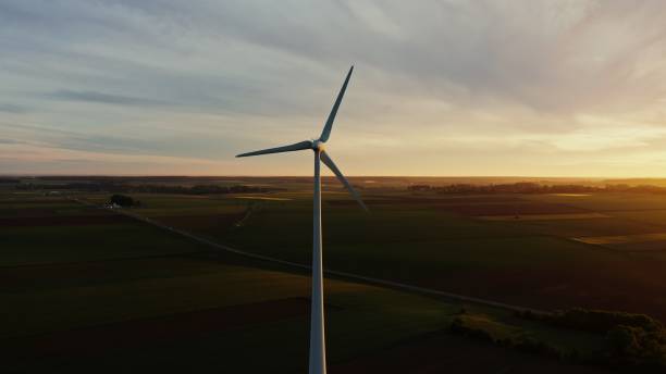 istock Horizontal panning from a drone, view of a wind farm among fields 2202172520