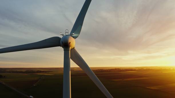 istock Horizontal panning from a drone, view of a wind farm among fields 2202172539