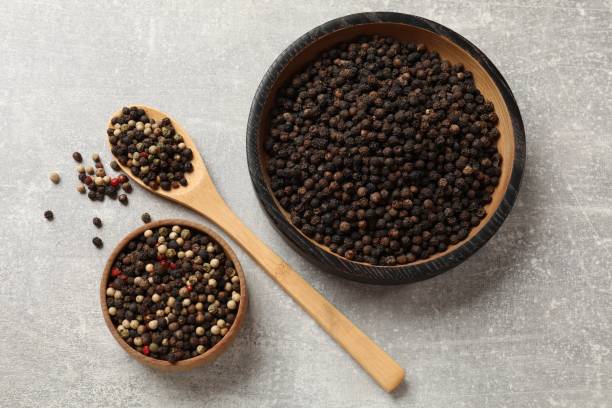 istock Aromatic spice. Different peppers in bowls and spoon on grey table, flat lay 2202175477