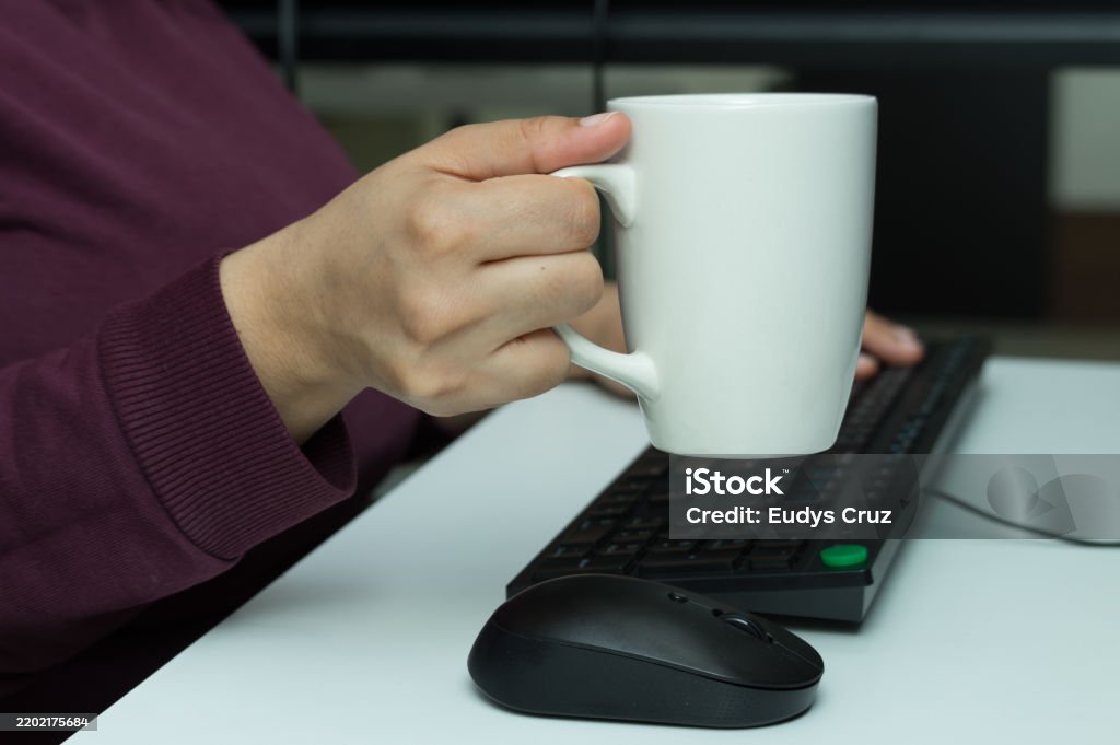 Computer Keyboard Mug Closeup Of A Hand Holding A Mug While Using A Computer Keyboard Stock ...