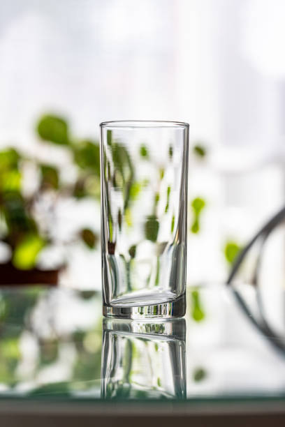 istock Clear Glass on a Sunny Table With Reflections 2202175719