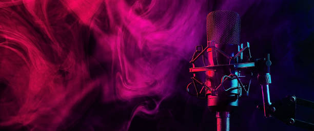 istock Professional microphone in red blue smoke on a black background. Widescreen. 2202177496