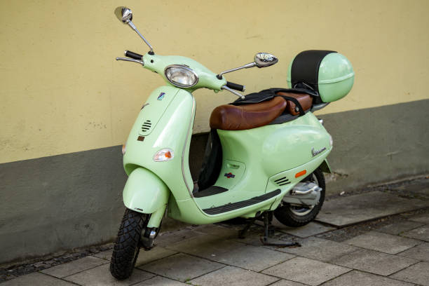 Munich, Germany, February 25, 2025. A mint Vespa scooter with top case. The Vespa is a motor scooter from the Italian company Piaggio. It is one of the best-known and most popular scooter typ