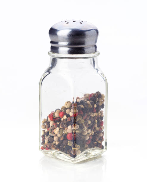 istock Glass spice jar filled with mixed peppercorns on a white background for culinary uses 2202177758