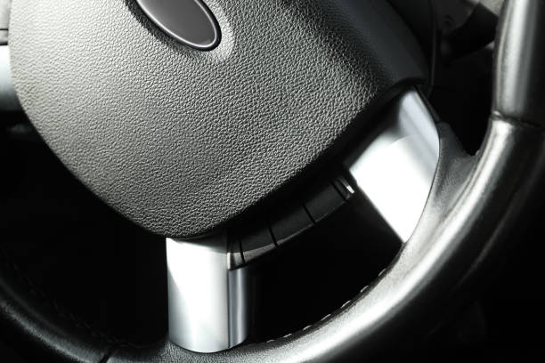 istock Black steering wheel as background, closeup view 2202179778