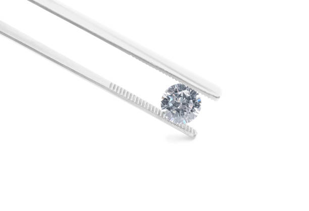 istock Tweezers with beautiful shiny diamond isolated on white 2202179812