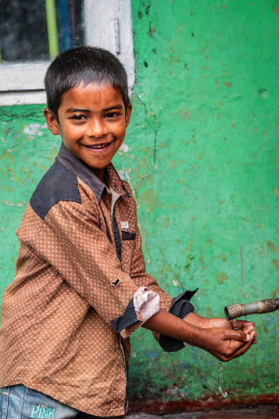 istock Sri Lankan young boy drinking a water, Ceylon 2202182574
