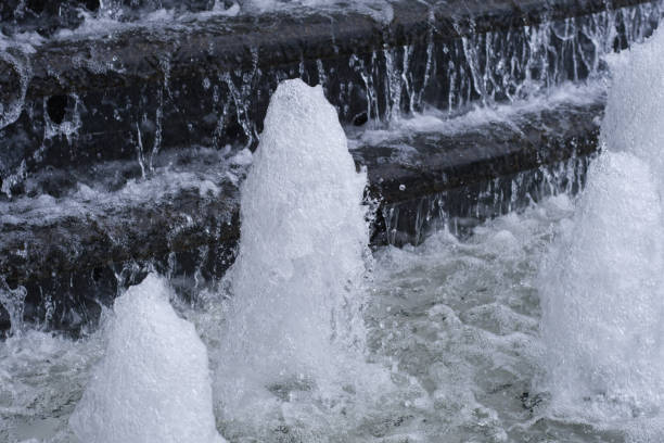 istock Fountain with water flowing over cascade steps. Urban city landscape design. Abstract background. 2202184737