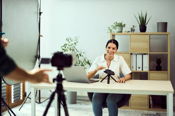 istock Businesswoman Recording Video Tutorial With Professional Camera in Office Setting 2202186534