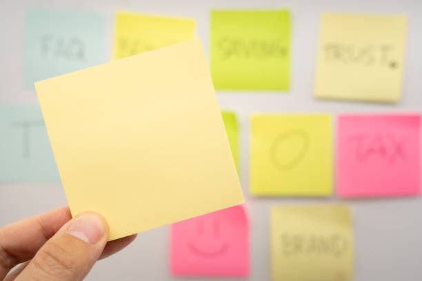 istock Hand holding Blank Sticky note with colorful sticky notes background. Copy space for text or infographic. 2202187335