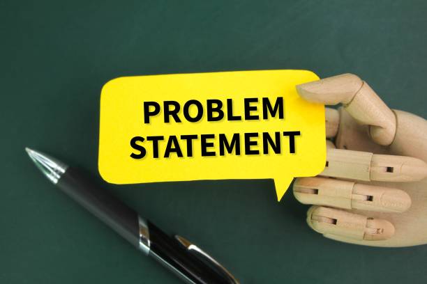 istock pen, wooden hand and colored paper with the word problem statement 2202189993