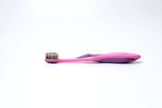 Pink child toothbrush with dirty brush