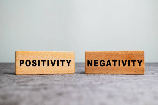 istock positivity and negativity on wooden blocks on the table 2202190792