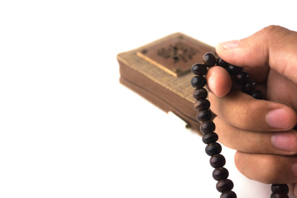 istock Hand Holding Prayer Beads Symbolizing Meditation and Spiritual Devotion on White Background 2202194522