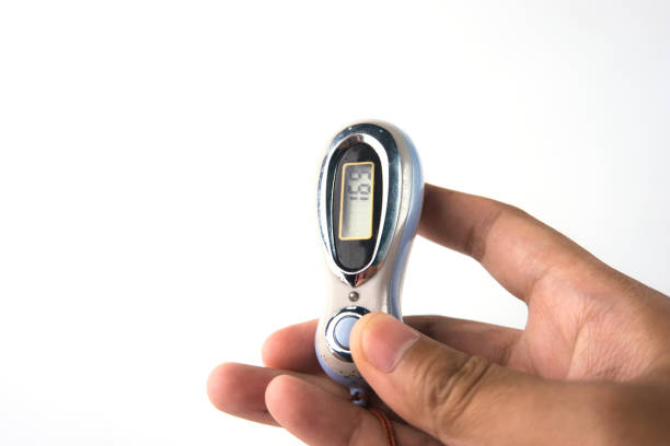 Close-up a hand gripping a compact digital counter. Ideal for tally counting dhikr or fitness tracking with a modern and practical style.