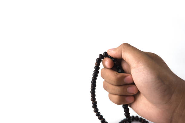 Close-up of a hand holding prayer beads, representing mindfulness, meditation, and spiritual connection. Ideal for themes of spirituality, religion, and calming practices for peace and self-awareness
