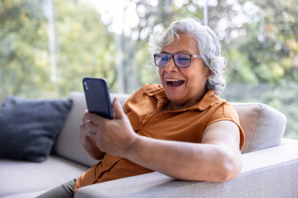 istock Senior woman at home talking on a video call using her cell phone 2202195052