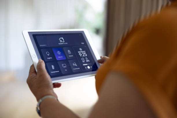 istock Close-up on a woman using a tablet to control her smart home 2202195055