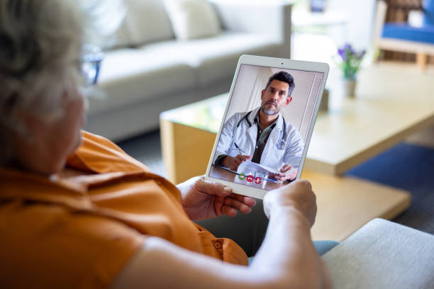 istock Doctor talking with a patient through a video call 2202195084