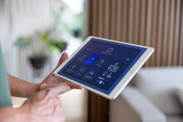 istock Close-up on a man using a tablet to control his smart home 2202195604