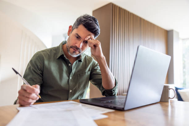 istock Man working at home and looking worried 2202196796