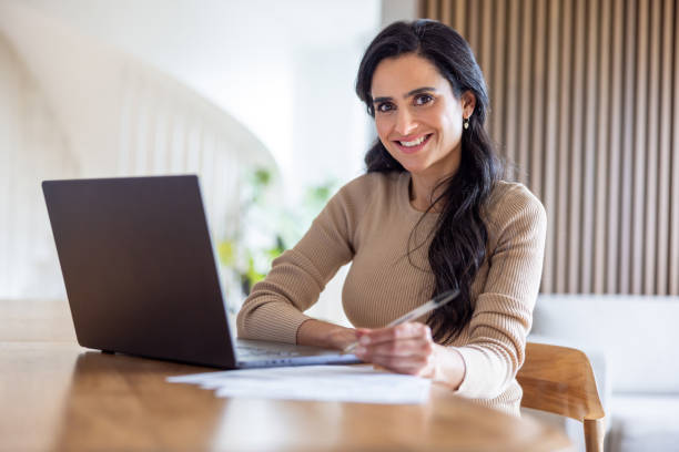 istock Woman working at home using her laptop 2202196808