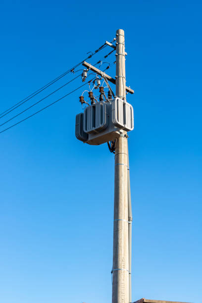 istock electricity transmission pylon, power line voltage tower against blue sky. 2202197077