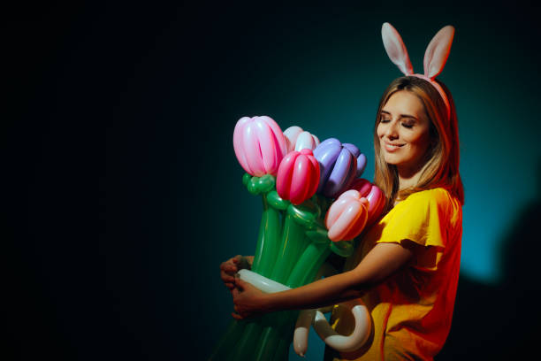 Easter background. Multi-colored Easter eggs - bunnies on the grass in the garden