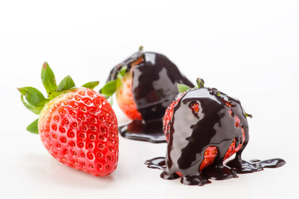 istock Fresh strawberries coated with rich chocolate sauce on a clean surface 2202200492
