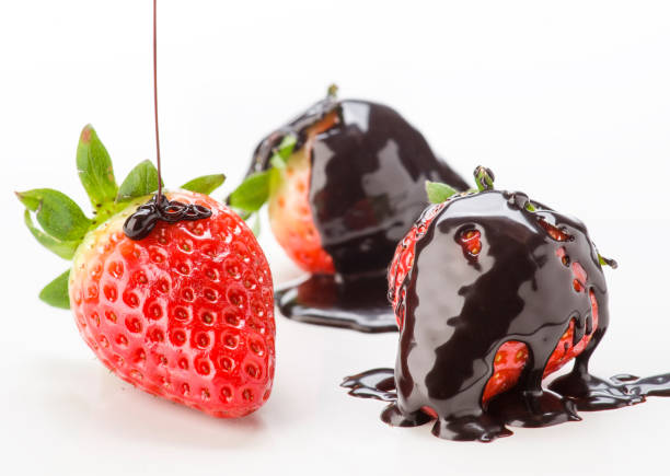 istock Fresh strawberries drizzled with rich chocolate in a bright setting 2202200516