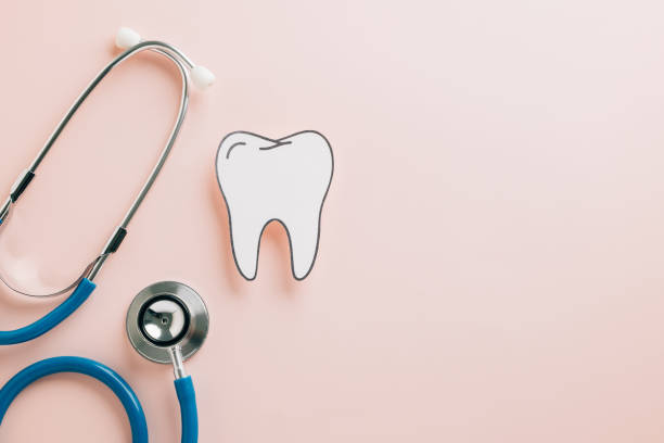 istock World Dentist Day mockup with tooth cutout and stethoscope on pink 2202200863