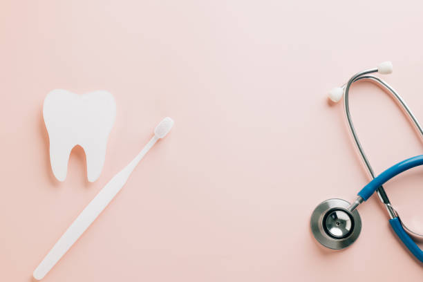 istock World Dentist Day mockup with tooth cutout and stethoscope on pink. 2202200874