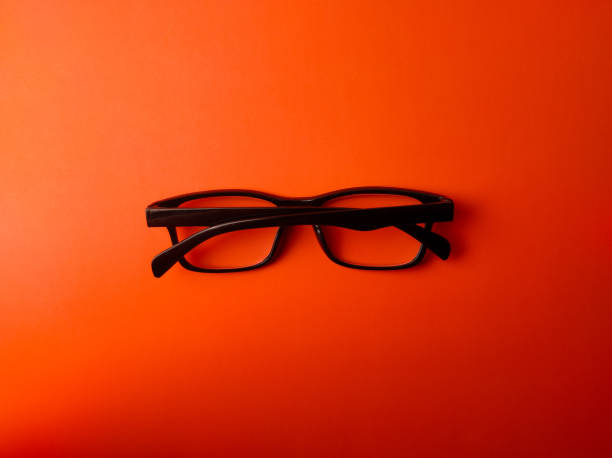 istock Top view black glasses on a orange background 2202203561