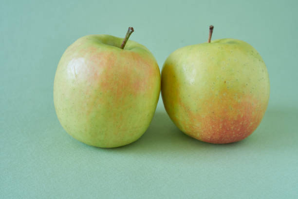 Red And Green Apples Side By Side On A Clean White Background, Highlighting Contrast In Color, Texture, And Freshness — Ideal For Concepts Of Choice, Comparison, Nutrition, And Healthy Eating.