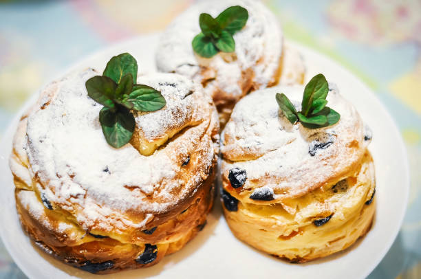 istock Three craffins sprinkled with powdered sugar and garnished with fresh mint leaves on a white plate. 2202209312