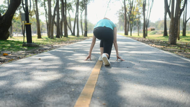 istock Sporty woman crouching down in starting position ready for sprint 2202210042