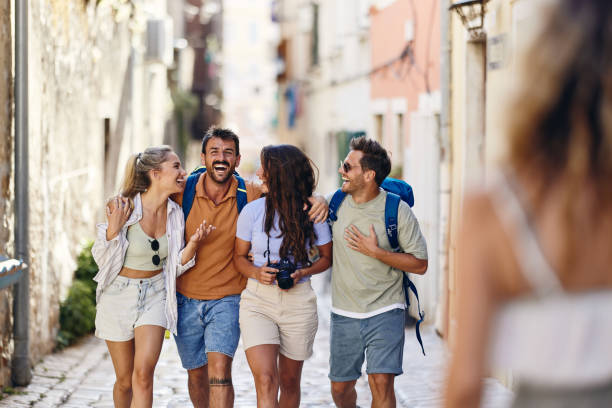 Cheerful tourists having fun while walking on the street.