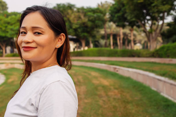 istock Woman laughing outdoors surrounded by green trees and a pleasant environment 2202211209