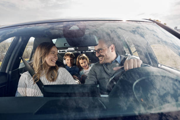 istock Happy family enjoying while going on a vacation by car. 2202212338