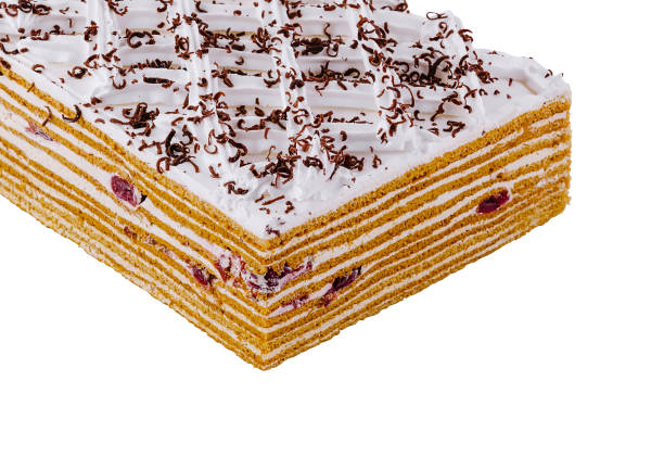 Delicious multi layered honey cake decorated with chocolate shavings and whipped cream
