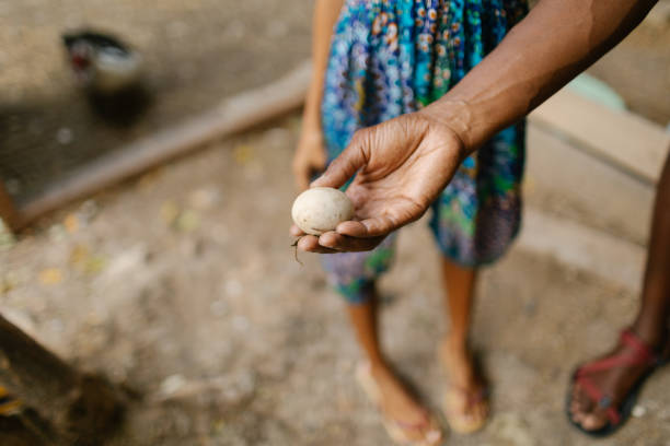 Man holding egg with child next to him